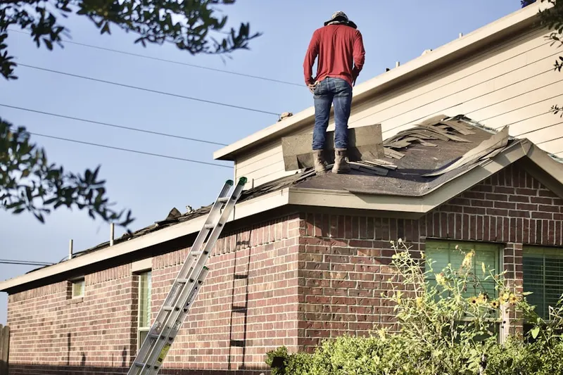 Professional roofer working on a residential roof in Spring Mill